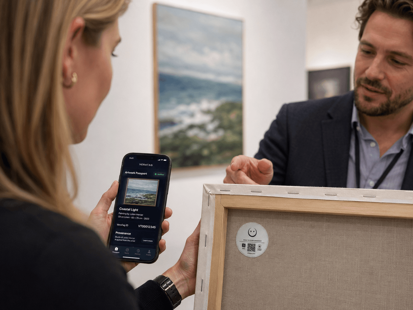 A gallery professional supporting a collector with a tagged artwork and digital passport